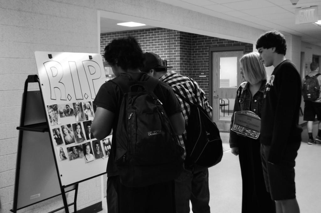 Students stare at their friends and teachers images in between classes, interested in who passed away.