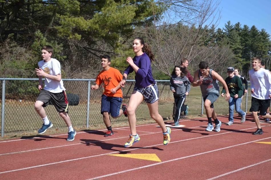 Unified Track athletes run laps at pratice.