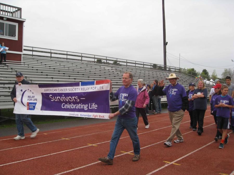 Survivors+carry+the+Relay+Survivor+banner+as+a+part+of+the+Survivor+Lap%2C+which+signifies+the+official+start+of+the+event.++Survivors+and+their+families+walk+to+celebrate.