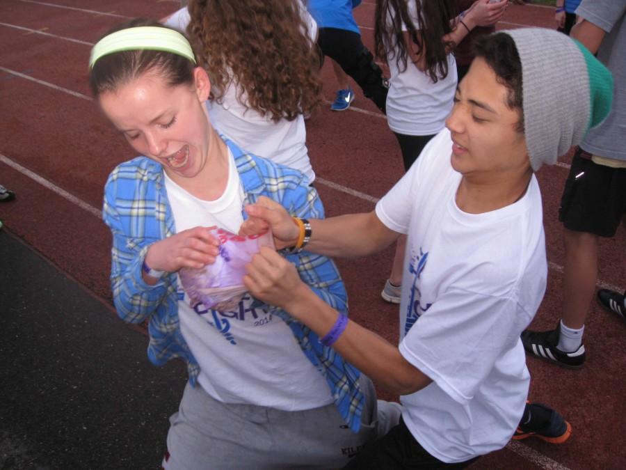 Freshmen Bridgit Kiley and Antonio Montilla struggle to break apart a rock-hard frozen t shirt.