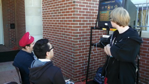 Junior Andrew Perry, president of the video game club, shows interested students what video game club is all about.