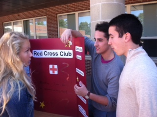 Senior Will Frank recruits senior Chrissy Foley to Red Cross Club.