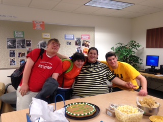 Leninne Batista (in stripes) poses with friends at his graduation celebration in E102.