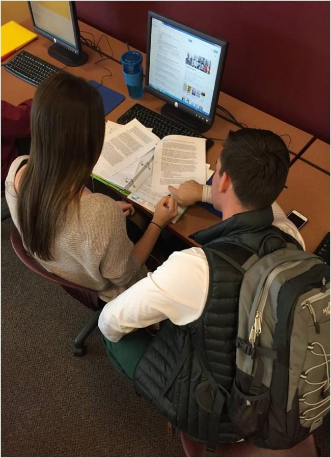 Junior Tess Lien and senior Tyler Hatton spend time doing work in the CRC.