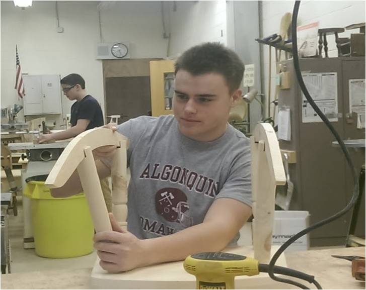 A rocking chair begins to take shape as junior Nate Cooley puts together his project.