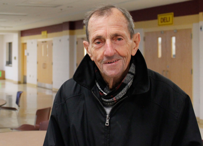 Mr.+Dick+Walsh%2C+whos+been+a+member+of+the+ARHS+community+for+more+than+60+years%2C+poses+for+a+picture+in+the+cafeteria+during+breakfast.