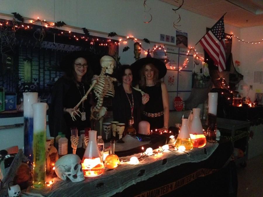 Chemistry teachers Lorraine Zanini,
Valerie Burdette, and Aimee Selby put on a Halloween show with a taste of science. 