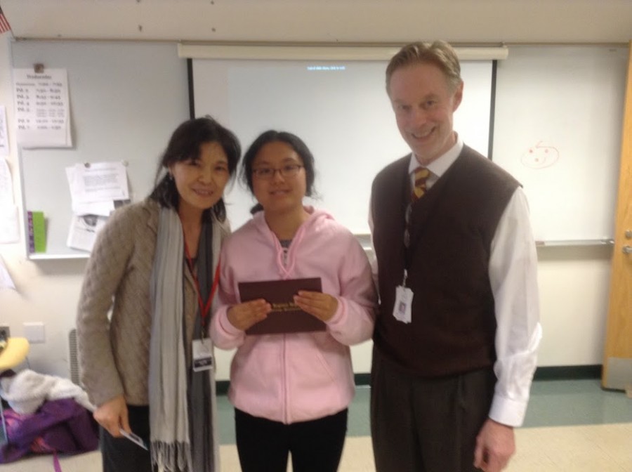 Li poses with her mother and Principal Thomas Mead, who awarded her with a certificate of completion for her participation in the CAP program.