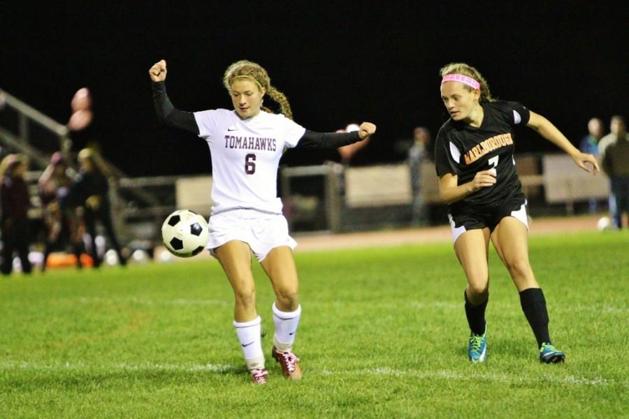 Sophomore Sydney Carney keeps the ball away from the Marlborough players.