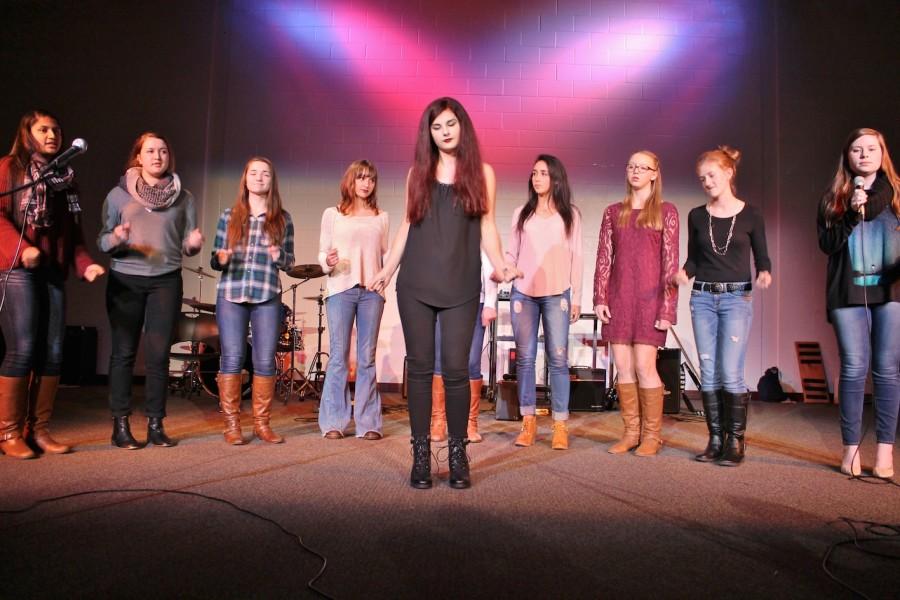 Sophomore+Mia+Murray+leads+Ladies+First+in+their+acapella+performance+of+Chains+by+Nick+Jonas+during+the+first+act+of+the+November+19+Coffeehouse.%0ALadies+First+are+%28from+left%29+junior+Sumati+Rangaraj%2C+sophomore+Katie+Zieminski%2C++sophomore+Nicole+Dobberpuhl%2C+junior+Chloe+Bernier%2C+sophomore+Jen+Piekarz%2C+junior+Anna+Benatuil%2C+freshman+Stehanie+Kalinowski%2C+and+senior+Annie+May.+