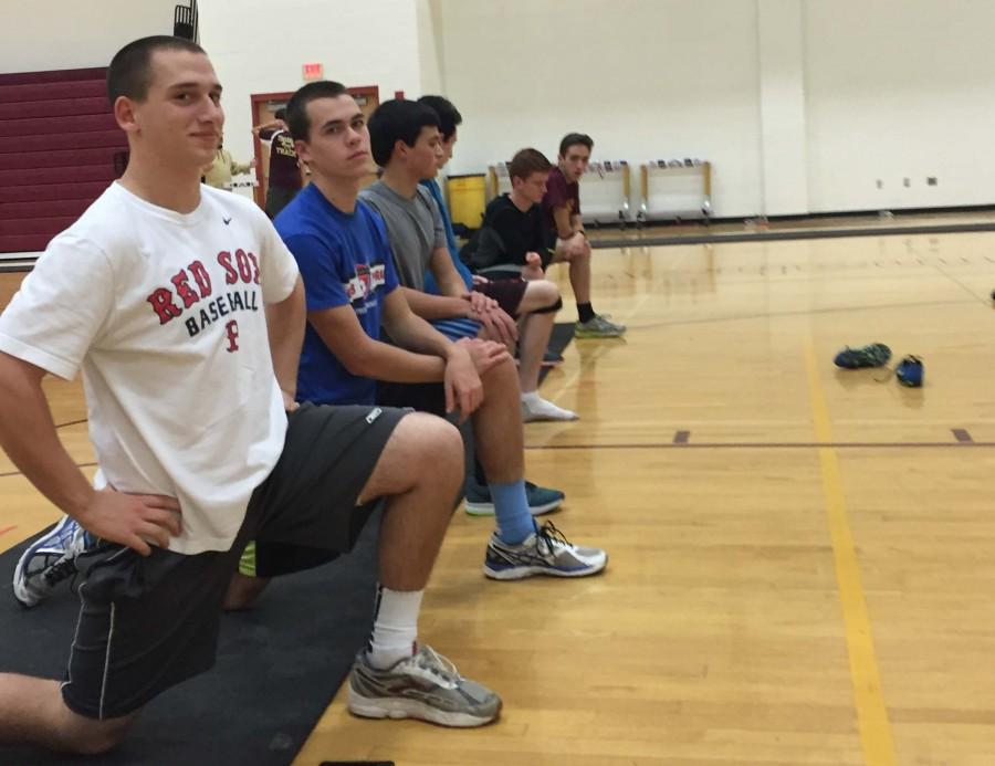 Members of the boys indoor track team stretch during a recent practice.