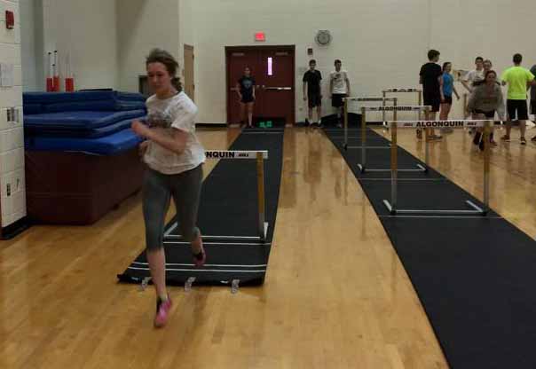 At a recent indoor track practice, senior Anna Dhoula practices hurdles.