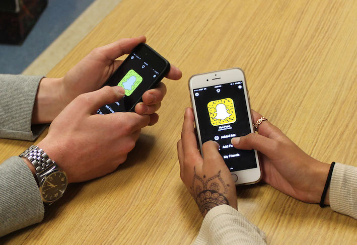 Students can become friends with each other on Snapchat in a variety of ways; seen above, students use QR codes to add each other. Popularity of the app has sparked several relationships between students and provides an easy way to get to know each other. 