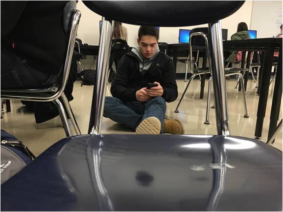 Senior Nick Hong relaxes on the floor and takes a break after he said, “I’m tired of sitting in chairs.
