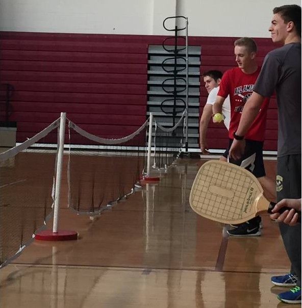 Seniors Andrew Travens, Connor Henderson and Ethan McRae engage in a pickleball tournament during gym class. 