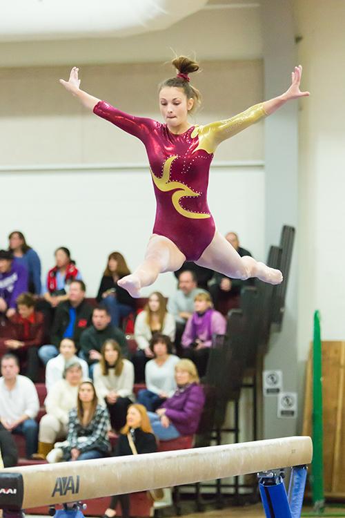 Leaping above the beam, junior Sam Brazeau competed against Hudson on January 6 2016. 