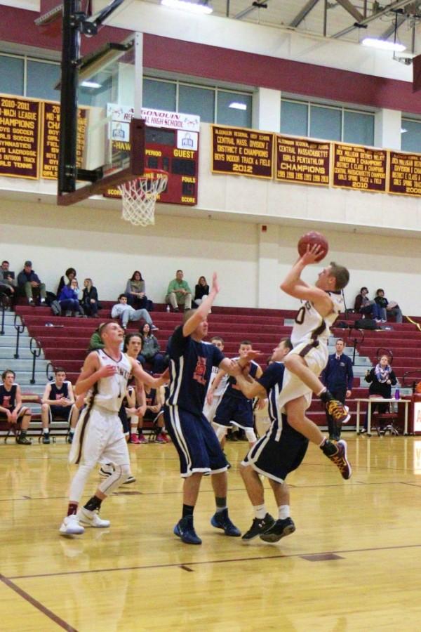 Sophomore Kyle Henderson leaps over a defender as he shoots