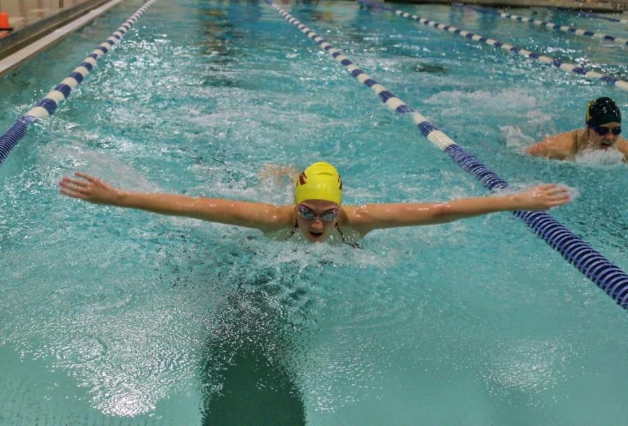 Freshman Tara McGillicudy races Gardner swimmer during butterfly.