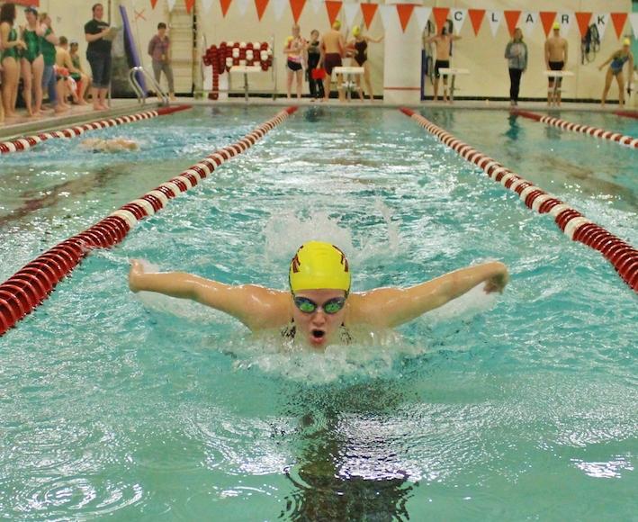 Slicing through the water, senior Darby Foster races in the butterfly against Nashoba in a meet on December 21. 