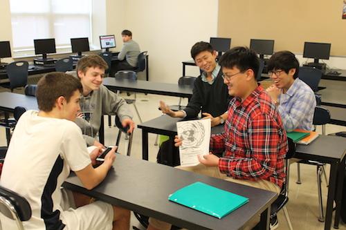 Freshman Christian Jorgensen and sophomore Michael Wu discuss their upcoming competition with juniors Ian Bourdon, Ian Kim, and Luke Kim looking on. The club competed in the UMASS Amherst United Nations Conference on March 11-13 and meets every Thursday after school in D109.