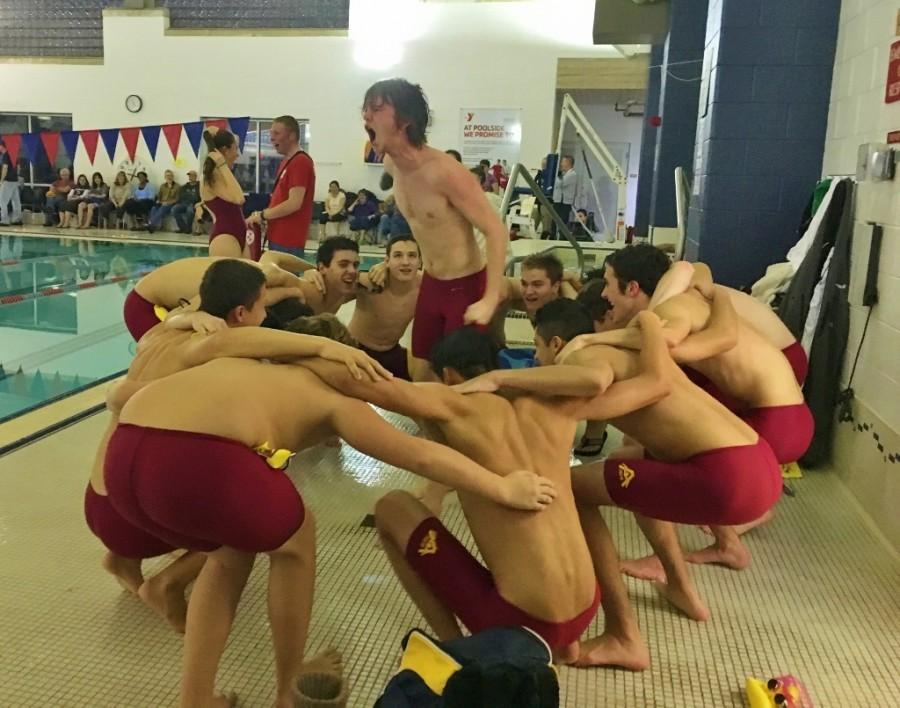 Following tradition, senior Peter Bryne leads members of the boys swim team in a pre-meet cheer against Westborough. 