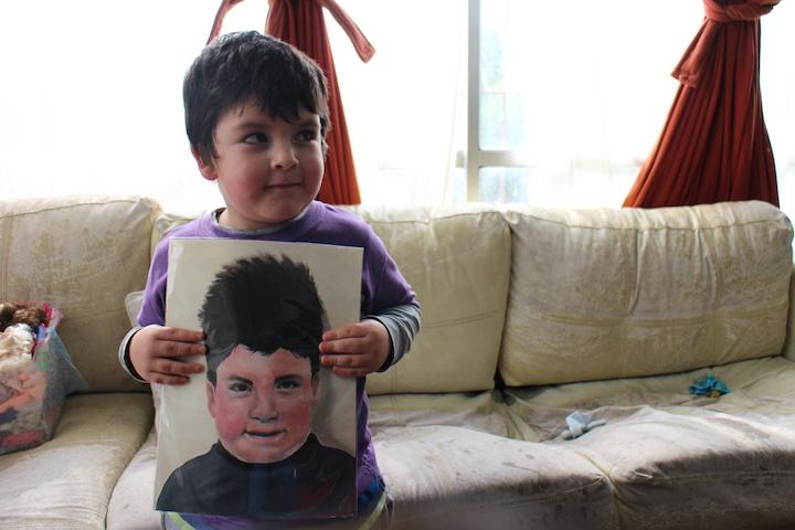 Children from Chilean orphanages display their portraits that were painted by National Art Honor Society students. 