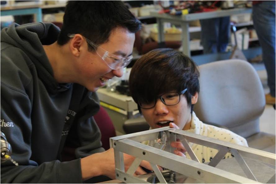 Robotics team members sophomore Alex Chen and junior Luke Kim work on this year’s competition robot.

