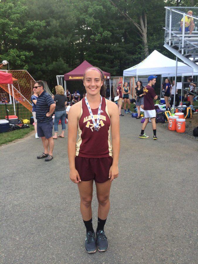 Senior Caroline Leonard poses wearing her medal after placing second in the javelin at the state competition on Saturday, June 4.