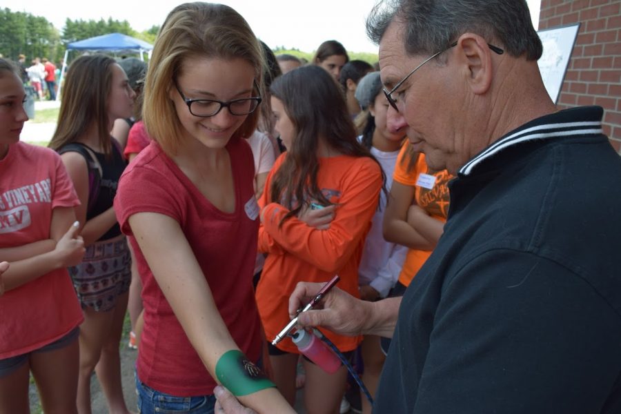 Junior Annalise Eppens receives a henna tattoo on carnival day,