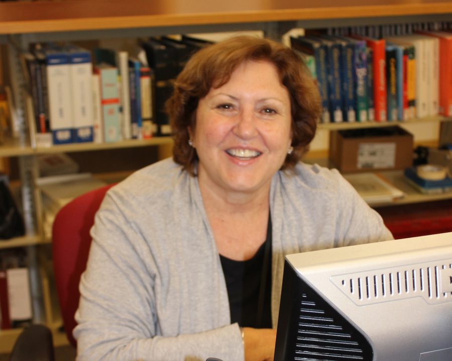 Library aide Cindy Sears is a friendly face to students as they study and socialize in the library. 