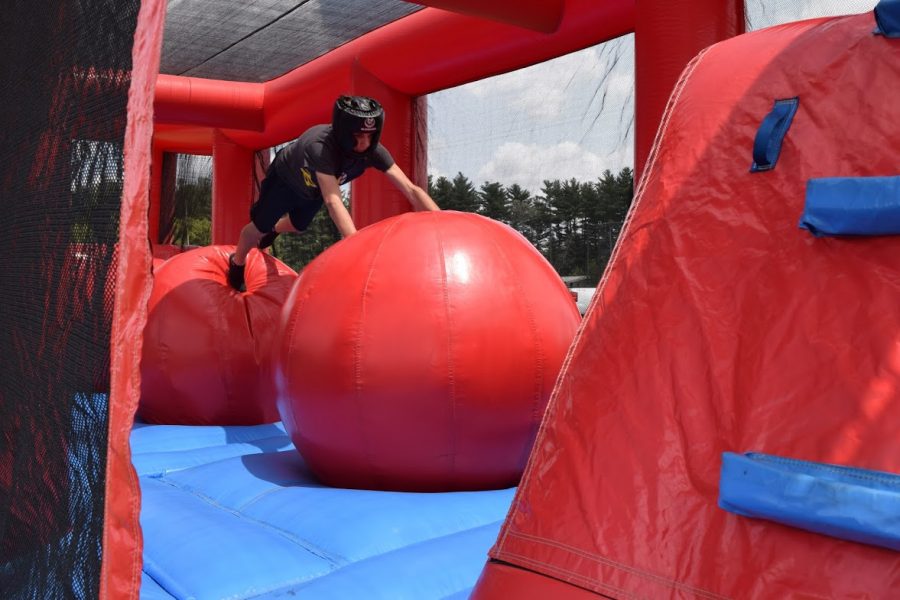 A student makes his way through an obstacle course in hopes to make it to the end without falling.