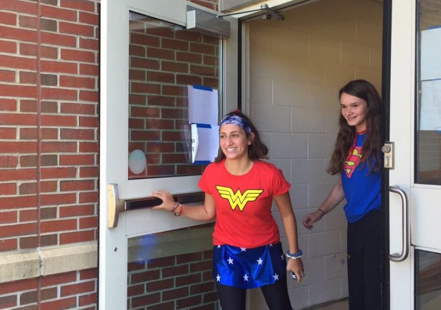 Freshmen Anna Lidsky and Jordan Manousos rush out of the exterior girls locker room doors in order to beat the alarm which sounds after 30 seconds.