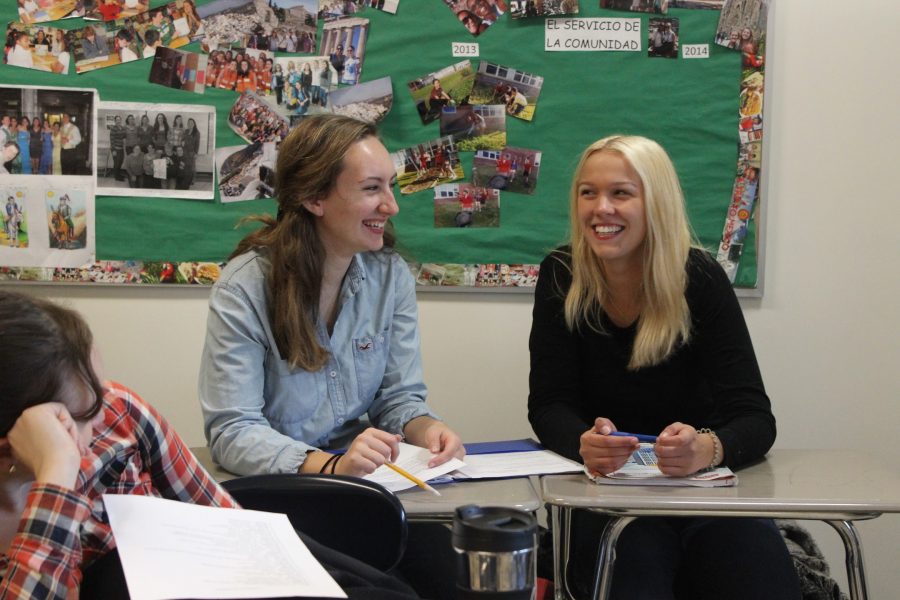 Junior Chloe Sainsbury takes a break during class and laughs with her exchange student Sarah Kohlstedde.