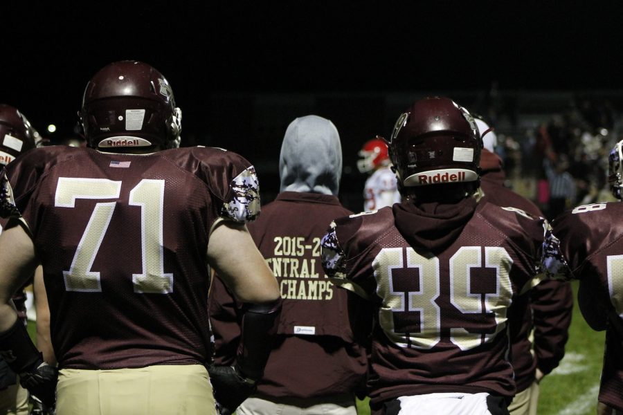 Teammates watch the game from the sideline during the home game against St. Johns on October 28.
