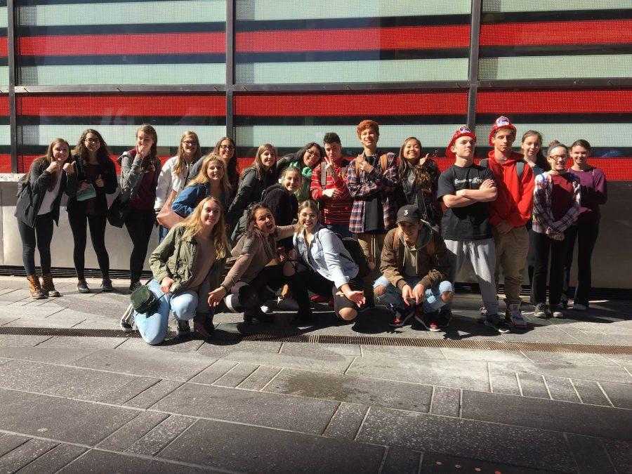 Fashion and textile students pose for a class photo along a New York City street. 