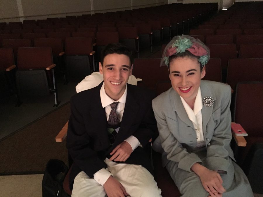 Junior Connor Macchi and senior Rachel Sachs pose for a photo in their costumes while watching their fellow cast members practice their scenes. 