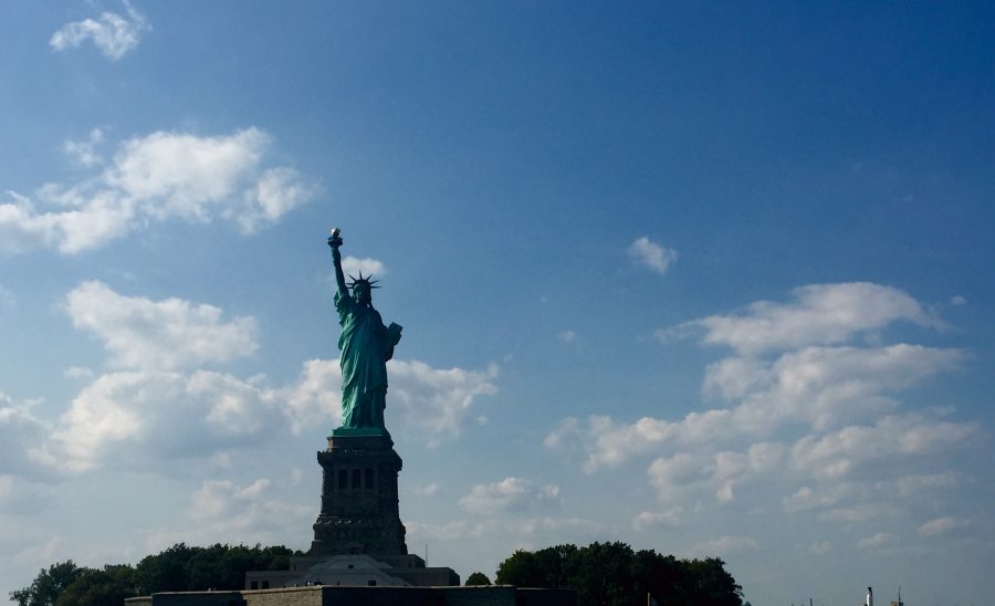 Ellis+Island%2C+where+the+Statue+of+Liberty+holds+her+torch+up+to+the+sky%2C+was+often+the+first+American+soil+immigrants+touched+after+their+journey.