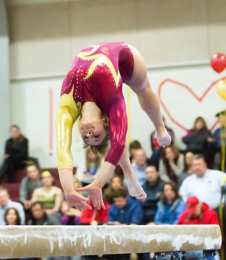 Sophomore Tessa McAndrews flips on the beam in a meet against Hudson with an Algonquin win of 133.15 to 128.60 on February 4.