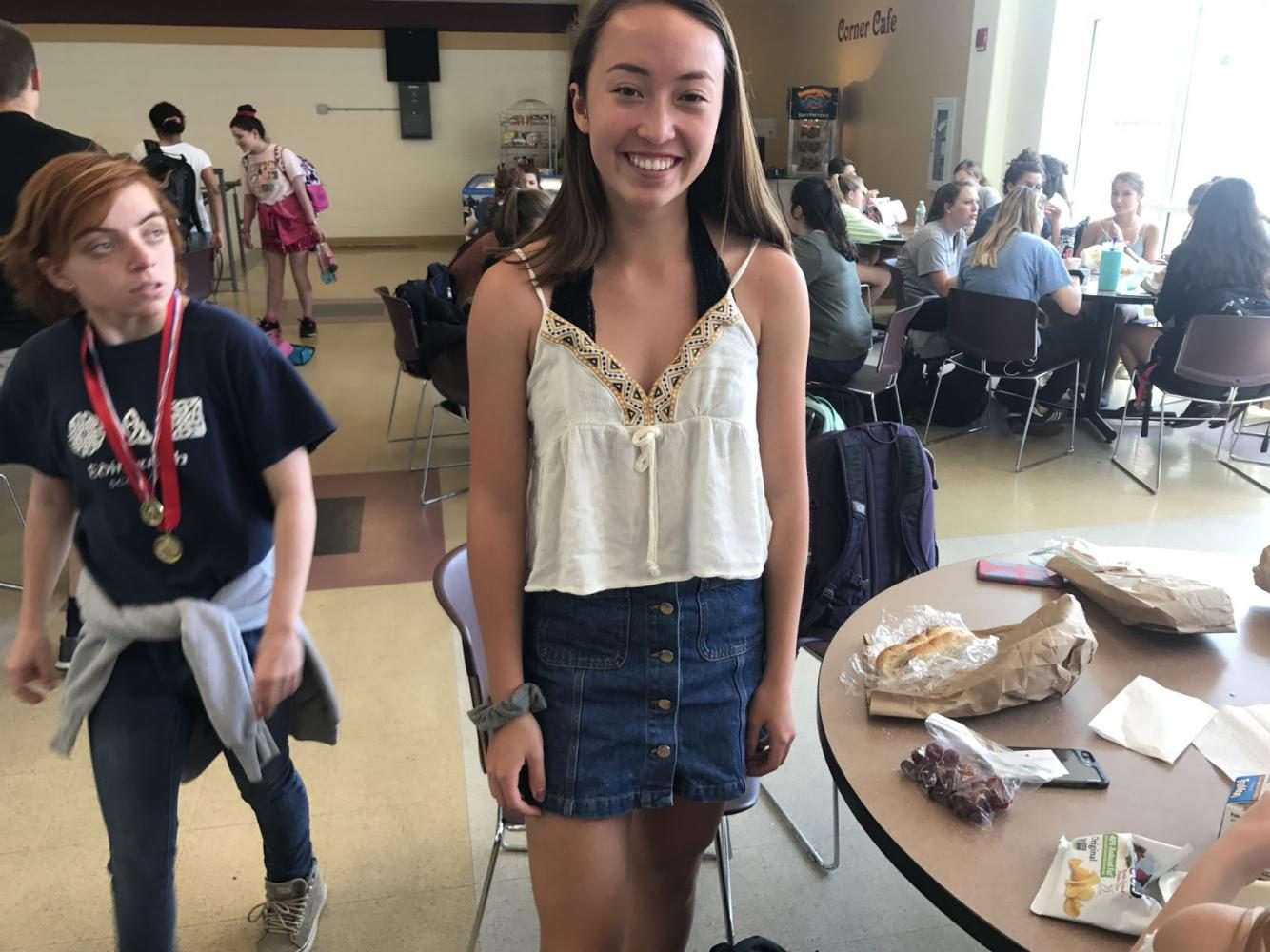 Smiling at lunch, sophomore Elaine Cho shows off a trendy jean skirt and patterned tank top. 