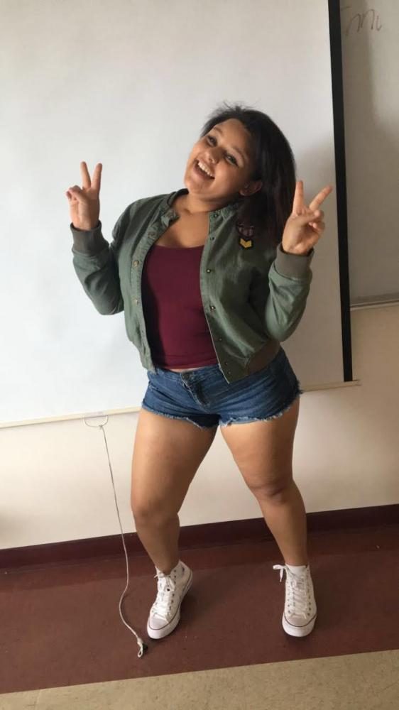 Freshman Victoria Smallwood jumps into summer with a fun and fashionable army green jacket over a magenta tank top, paired with jean shorts and white Converse.