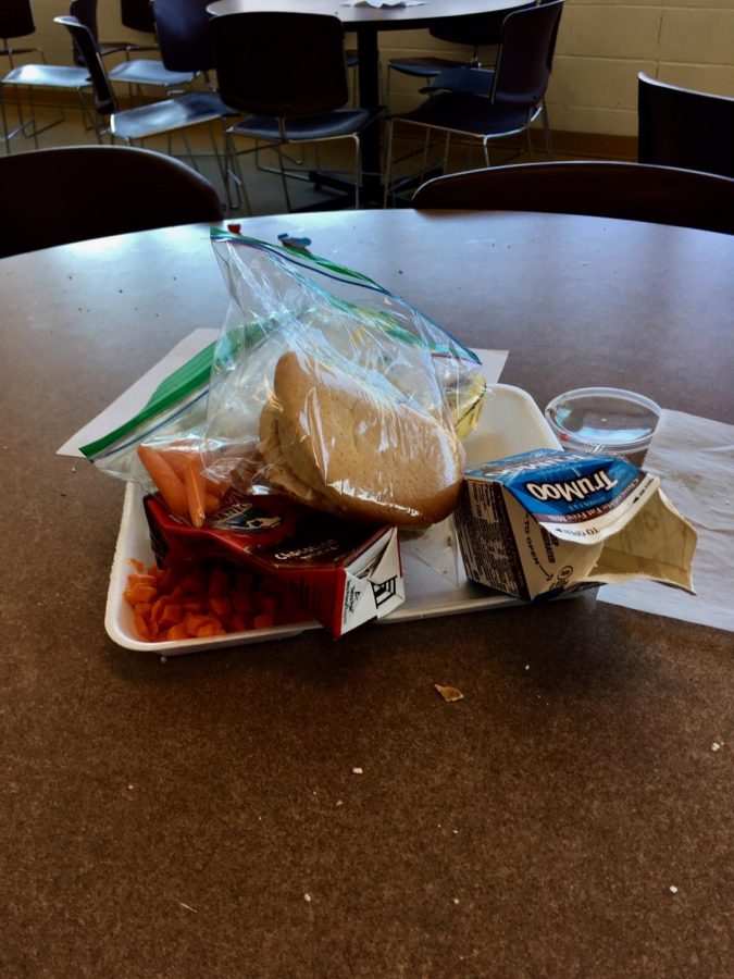 Waste is left on cafeteria table after third lunch: a styrofoam tray topped with plastic bags, food, and cartons of beverages. According to Sustainability.wustl.edu in “The Environmental Impacts of Styrofoam,” the petroleum based styrofoam is the main pollutant of oceans and other water sources, and contributes to large amounts of greenhouse gases. 
