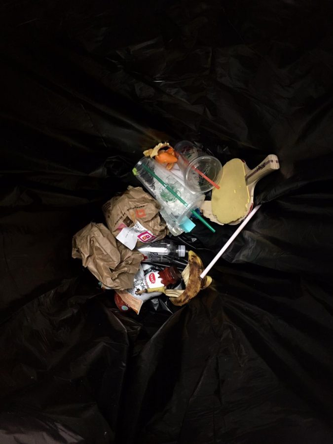 Waste of students and teachers begin to pile in the gym garbage bin: a pingpong paddle, plastic bottles, Dunkin Donuts and Starbucks coffee cups.