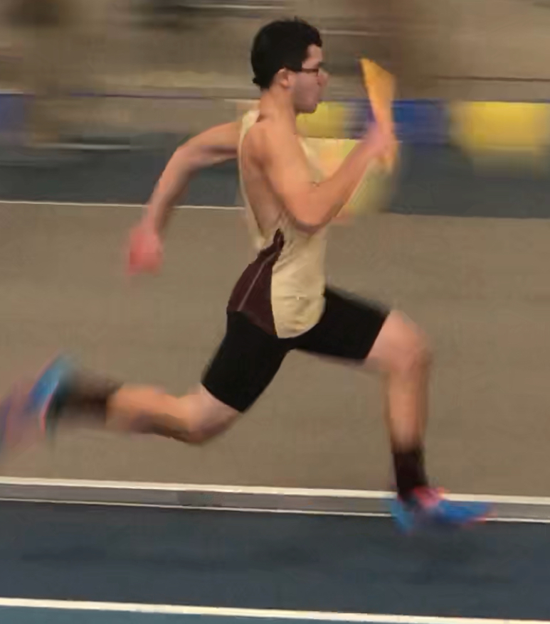 During the 4x200 meter relay, junior Luke Aspero runs the second leg for his team at the Reggie Lewis track. “I really love the team, we’re family and it shows when we run,” Aspero said. 