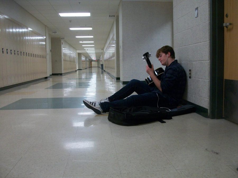The halls are nearly empty on Friday afternoon, save for junior Benjamin Vroman filling the silence with guitar notes.