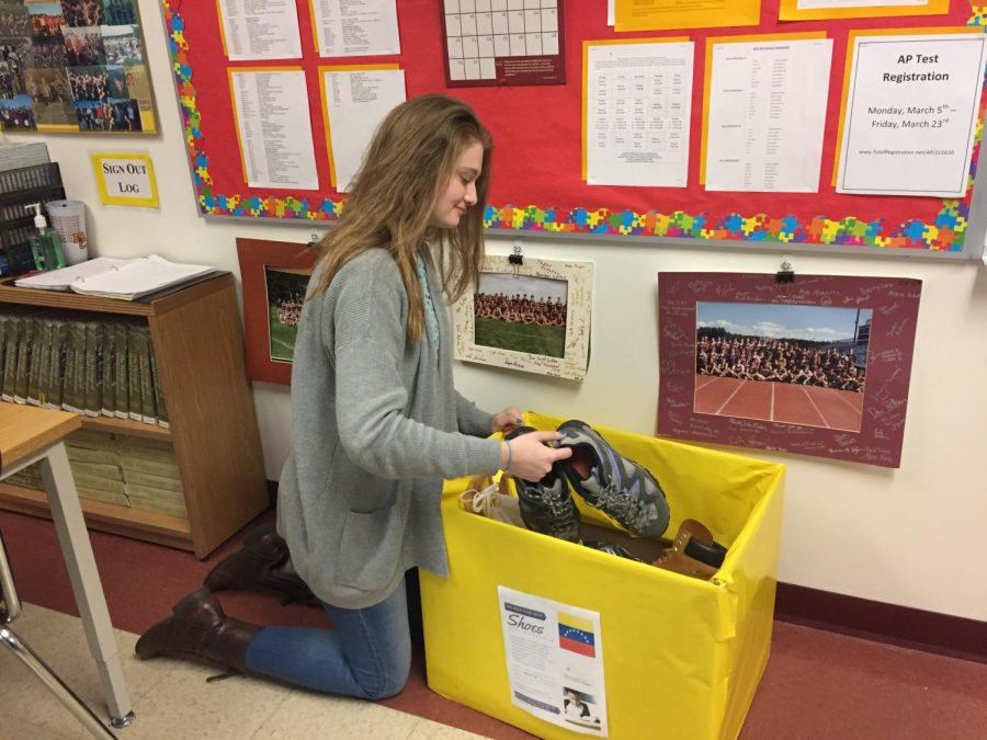 Junior Anna Hoskins placed boxes in classrooms around the school in efforts to collect shoes for children in Venezuela. 