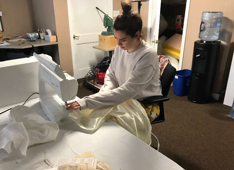 Junior Julia Casapulla works on the custom-made dress she is wearing to prom.