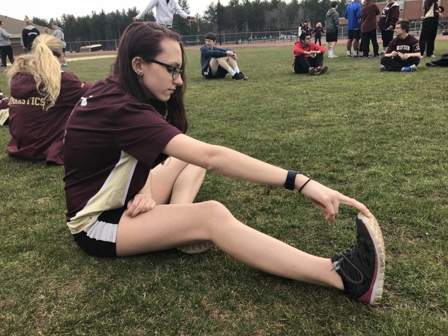 Junior Leah Barker stretches her legs on the football field to prepare for the meet. “Even something as simple as stretching is made fun with The Unified Track team. Everyone is always smiling and has a good attitude!” Barker said.
