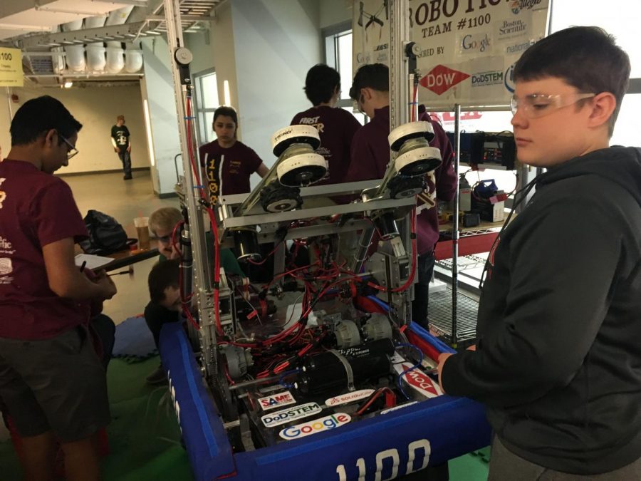 Sophomore Tejas Maraliga (left) and AMSA junior David Gigliotti (right) are make last minute fixes to the robot before one of their elimination matches.