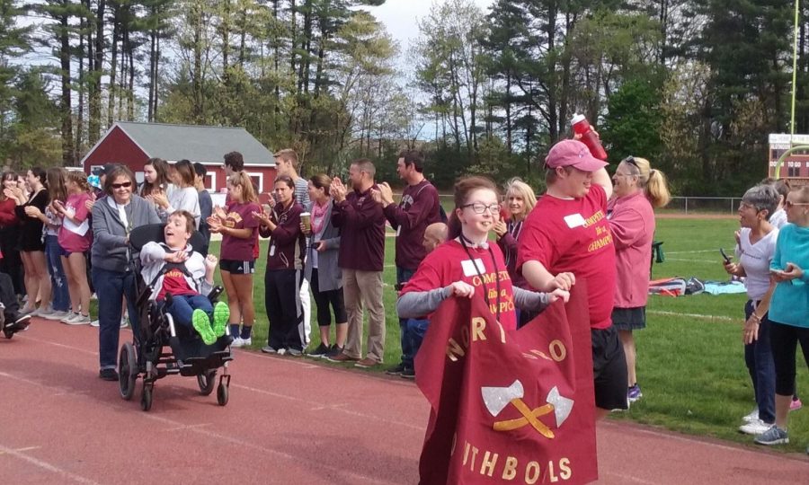 Freshman Julia Cobb leads the parade with an Algonquin banner.