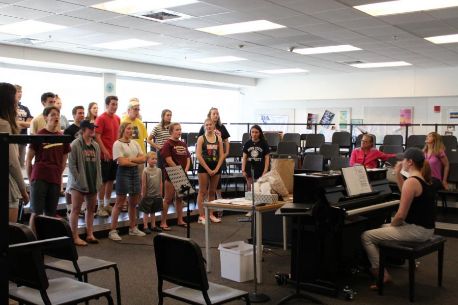Members of the cast of Wegmans: the Musical! rehearse with songs inspired by those from famous musicals ranging from Les Miserables to Hamilton. 